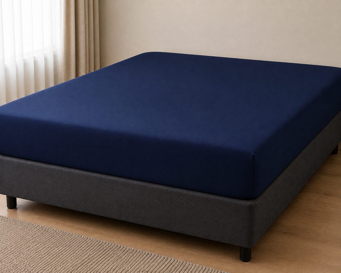 Navy blue King fitted bed sheet on a bed base