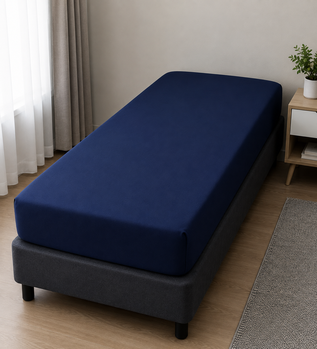 Navy blue Single fitted bed sheet on a bed base